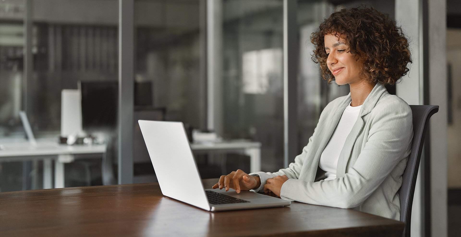 Businesswoman using laptop at table