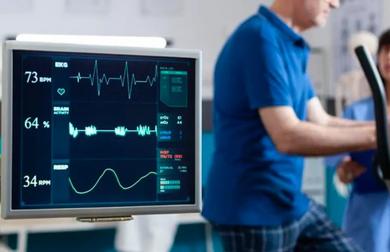 Cardiology practice using modern diagnostic tools — heart rate monitor displaying vital signs during a patient stress test, symbolizing digital transformation in healthcare workflows.